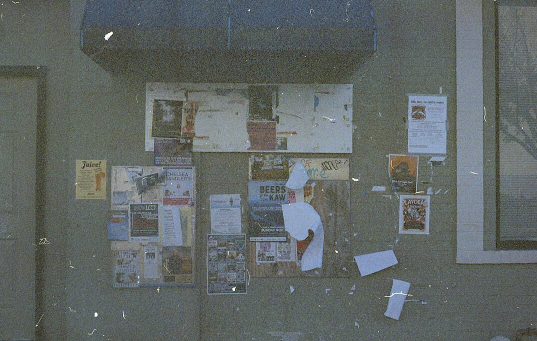 Investigative journalist desk with documents, laptop and pinned photographs on a cork board